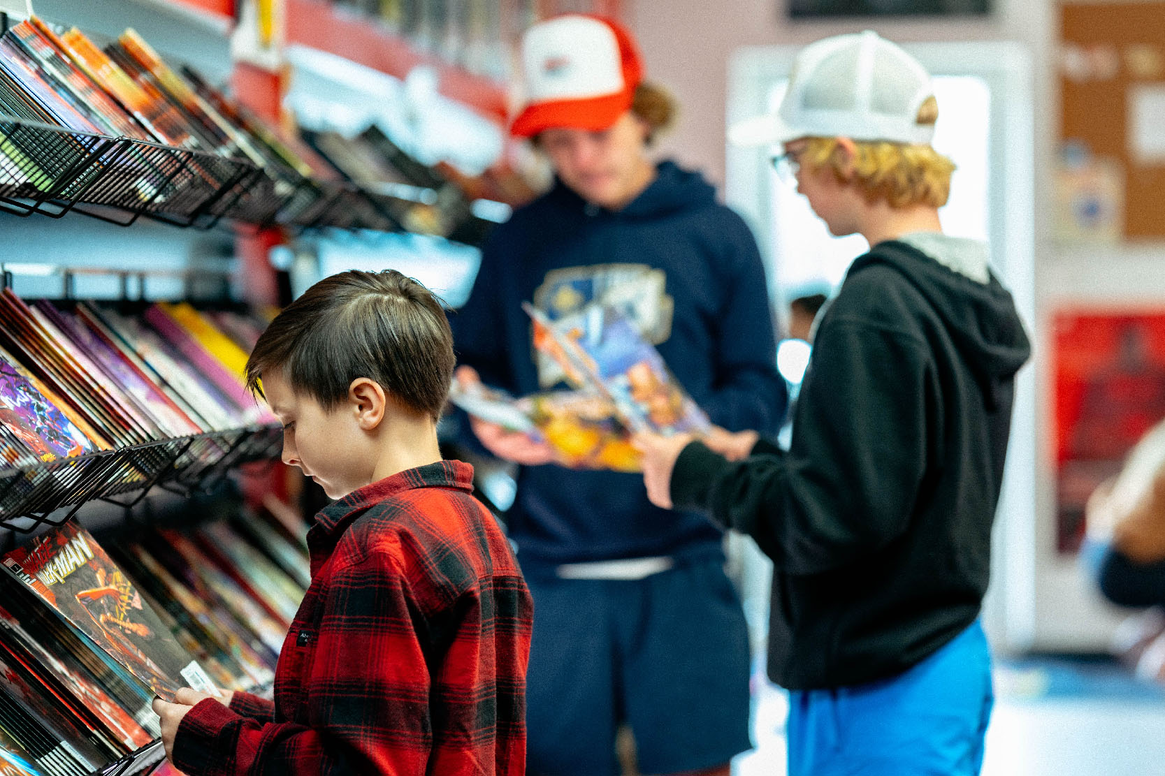 Customers browsing comic book shelves in a comic store, reflecting the storytelling inspiration behind the marketing approach