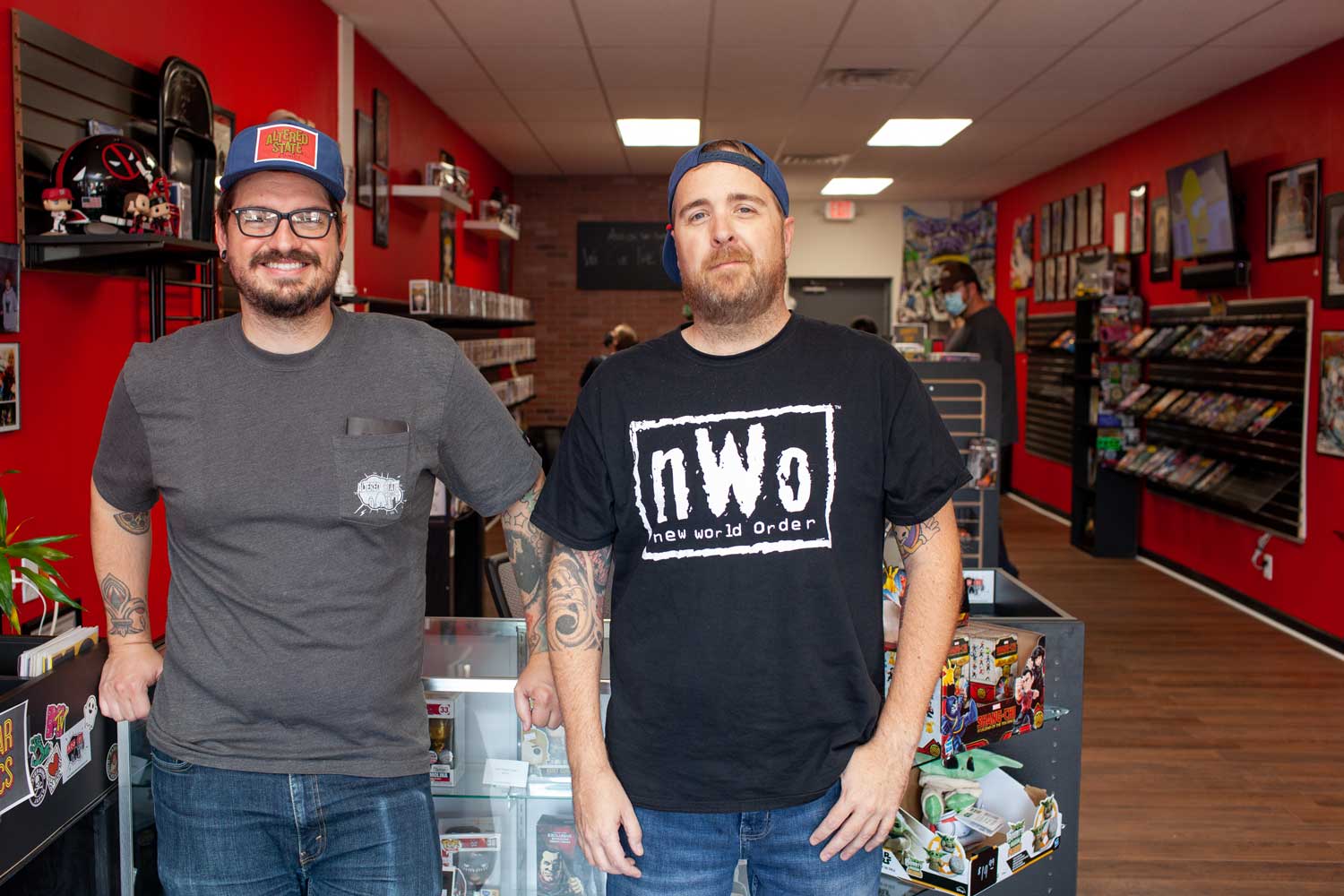 Two men standing inside a comic book store, representing the authentic roots of a marketing journey